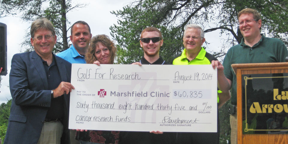 Clinic researchers receive check from successful fundraiser